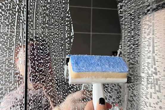 Clean the glass with a sponge