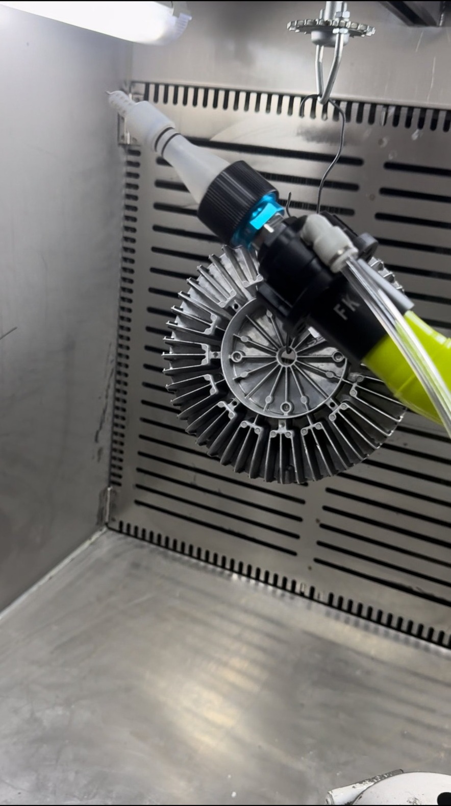 Q7 powder coating gun penetrating deep parallel fins of an aluminum heat sink, demonstrating Faraday cage breakthrough