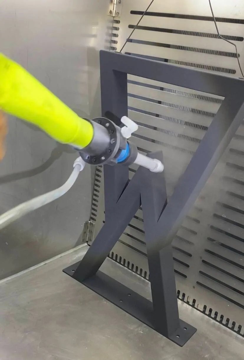 Q7 handheld gun coating internal angles of a steel furniture frame with full powder coverage