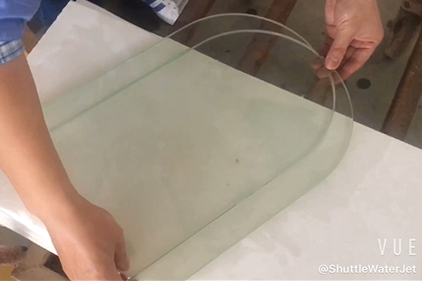 Water jet cuts glass with different designs